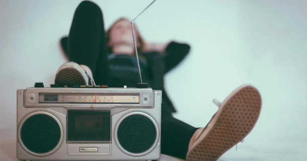 a woman lying and listening to the radio podcast