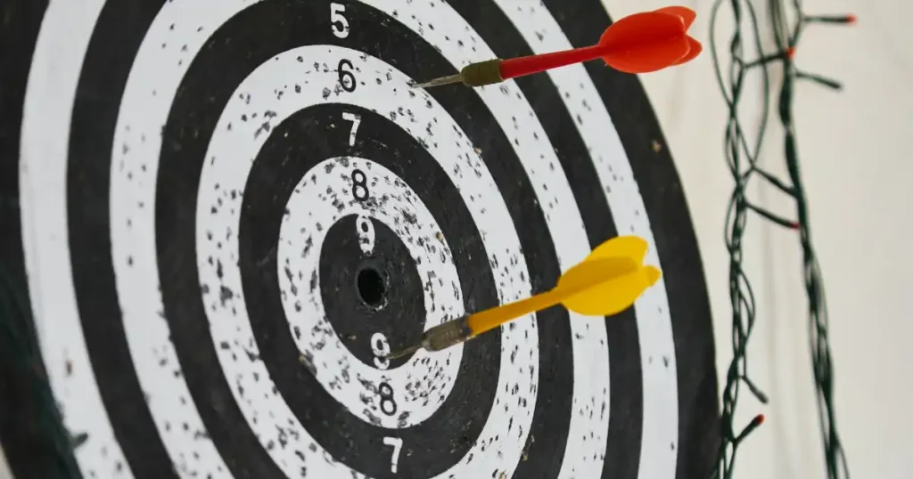 a dartboard and two darts on it